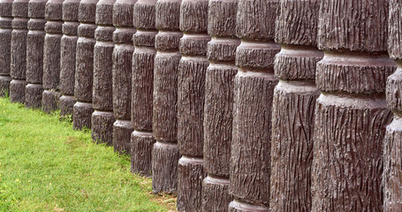 Cement pole in wood like in curve line