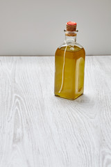 Bottle of artisian olive oil virgin extra isolated on wooden tab