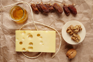 Emmental cheese with dried datils, walnut, honey on craft brown