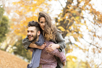 Fototapeta premium Young couple in the autumn forest