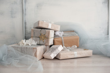 Fototapeta na wymiar Wrapped gift boxes with silver Christmas ornaments