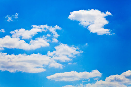 blue sky with white fluffy clouds background