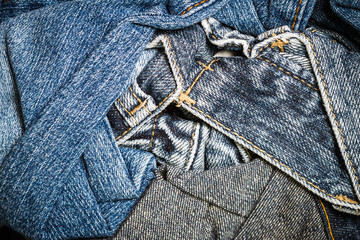 Close up of texture of many jeans trouser stack background