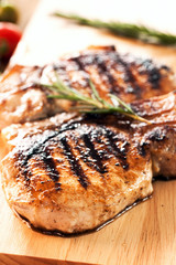 grilled pork chop on wooden board