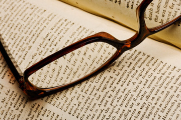 Old book with glasses