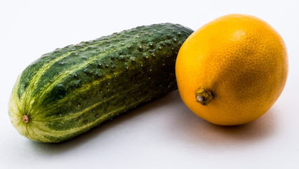 Изолированный зеленый огурец и желтый лимон на белом фоне