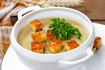 Vegetable soup with pieces of toasted bread and parsley.