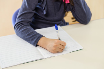 Girl at desk writing