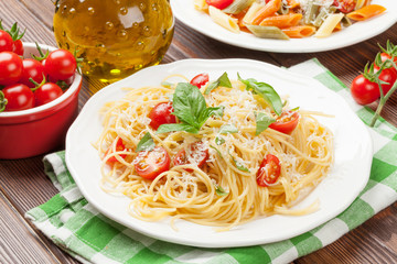 Spaghetti and penne pasta with tomatoes and basil