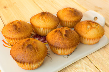 Muffins on a white porcelain board, selective focus
