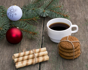 coffee, two linking of cookies and a coniferous branch with scen