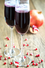 Two glasses of champagne with pomegranate seeds