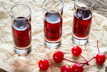 Glasses of cherry brandy with cocktail cherries