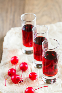 Glasses of cherry brandy with cocktail cherries