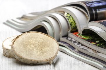 stack of magazines on a white wooden background