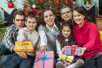 Portrait of happy multigeneration family with Christmas gifts si