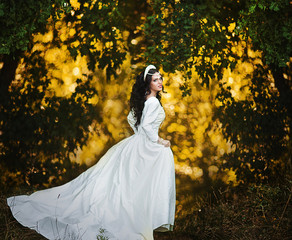 Wedding. Young beautiful bride with hairstyle and makeup posing in white dress