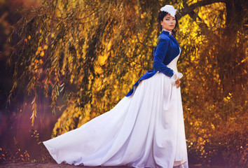 Fototapeta premium girl in a vintage dress in the autumn forest