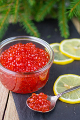 Salmon caviar. Red caviar and lemon. New year. Traditional Russi