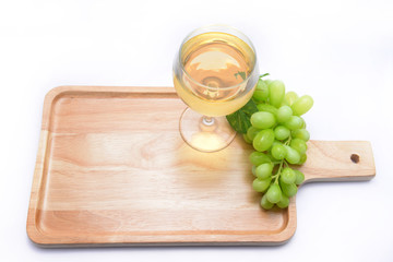 white wine and grapes on a wooden floor.