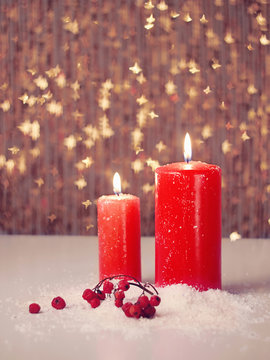 Candle and berries on snow