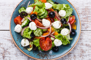 Greek salad , mini mozzarella in a bowl shape.selective focus