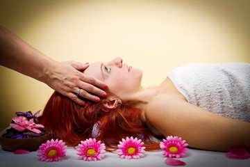 Obraz na płótnie Canvas Beautiful young woman receiving facial massage in a spa salon
