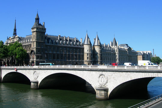 Classic architecture with Palais de Justice castle and bridge over Seine river in Paris, France
