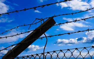 Barbed wire on blue sky