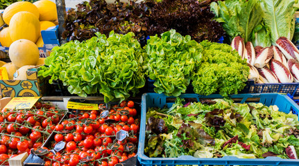 market with various colorful fresh fruits and vegetables. Farmer