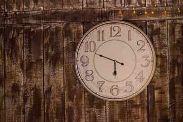 Old clock on grungy wooden wall