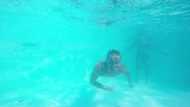 Two men diving in swimming pool