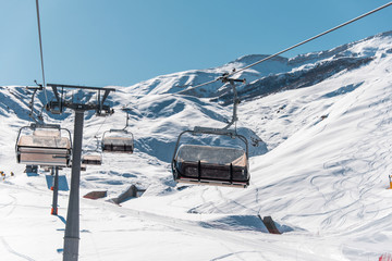 Fototapeta na wymiar Ski lifts durings bright winter day