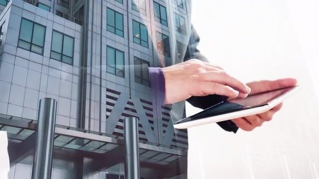 London office building double exposure with businessman touching tablet screen