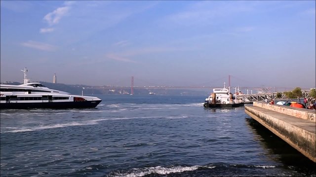 Ferries arriving and departing from a river pier in downtown Lisbon, Portugal
