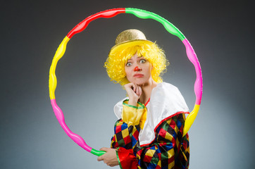 Clown in funny concept on dark background