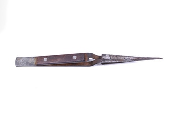Old metal tweezers on a white background