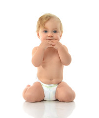 Infant child baby girl in diaper sitting happy looking at the ca