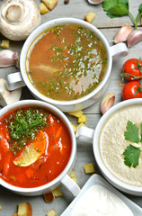 soup bowls mashroom cream soup fish and tomato in bowl with crou