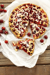 Tasty homemade pie with cherries on table close up