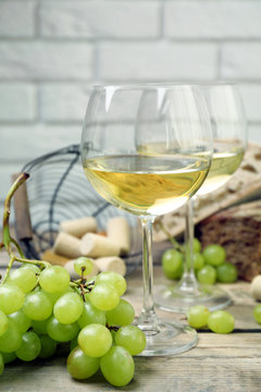 Still life of wine and bread on light background