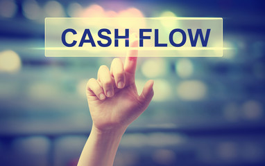 Cash Flow concept with hand pressing a button