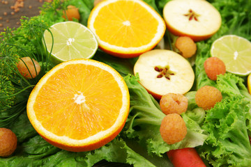 Yellow fruits and green herbs background