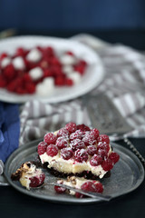 Sweet cake with raspberries on color wooden background