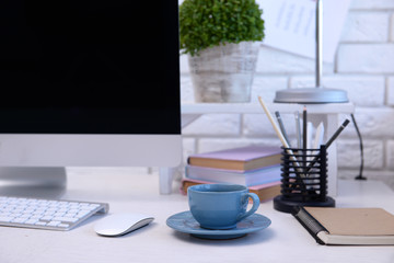 Workplace with computer and laptop on the table, close up
