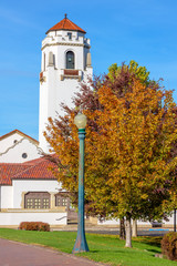 White train Depot with autumn trees and bell tower