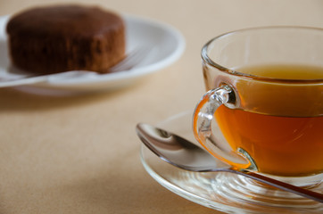 Glass Cup of Tea and Chocolate Cake for Tea Break.