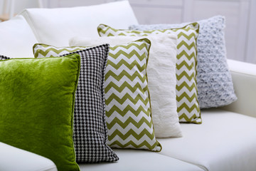Sofa with colorful pillows in room