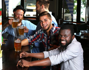 Young men drinking beer in pub