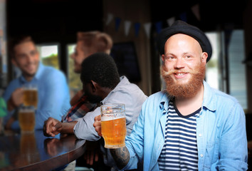 Young men drinking beer in pub